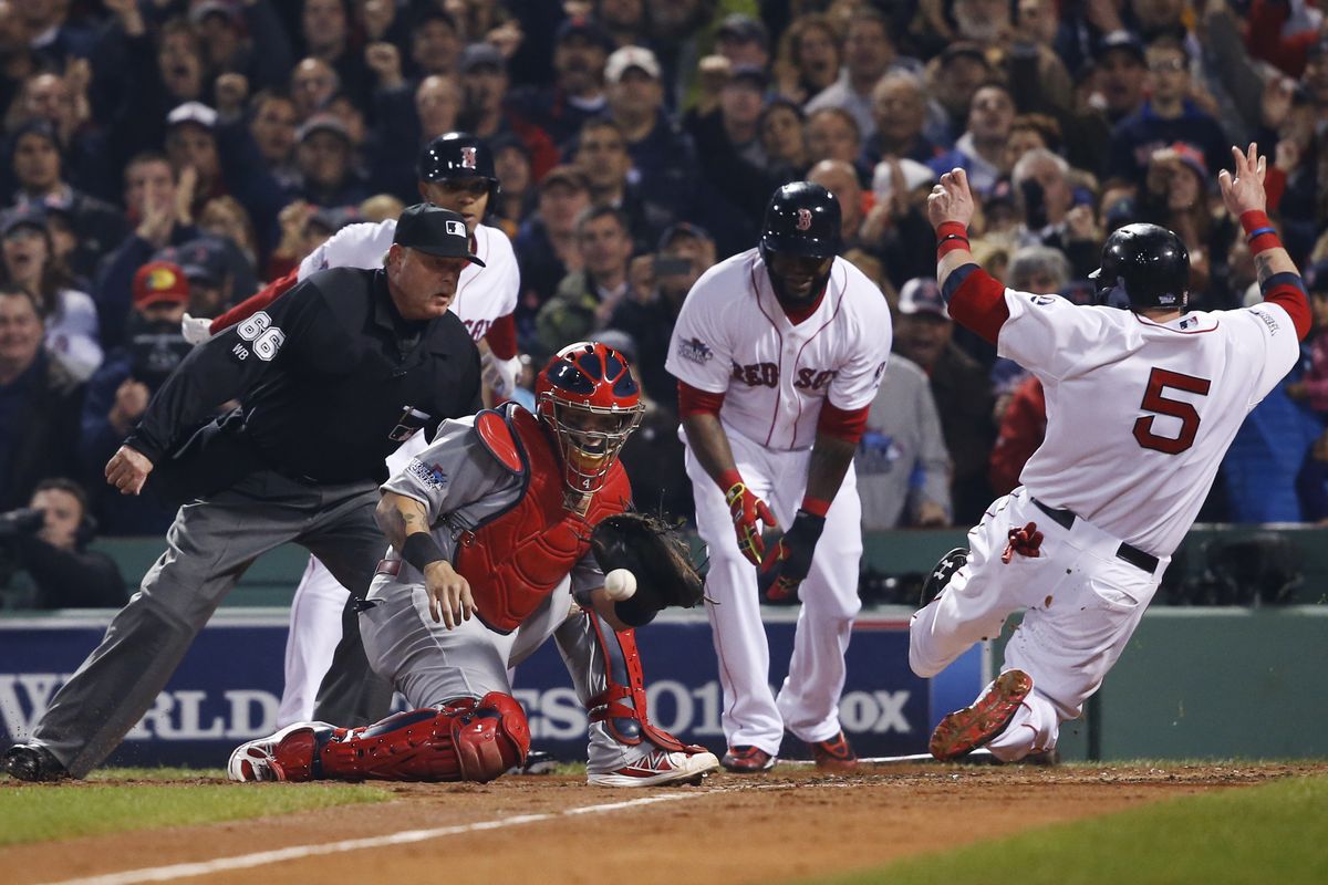 From left, home plate Jim Joyce, Xander Bogaerts and David Ortiz watch as Jonny Gomes beats tag of St. Louis catcher Yadier Molina.