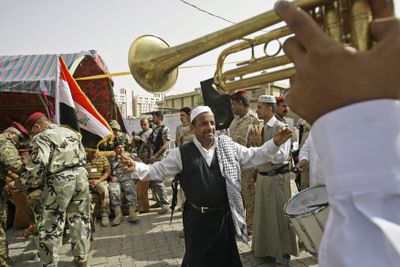 A band plays during a ceremony  to mark the reopening of al-Rasheed Street in central Baghdad on Sunday. The street was open to traffic for the first time in four years.  (Associated Press / The Spokesman-Review)
