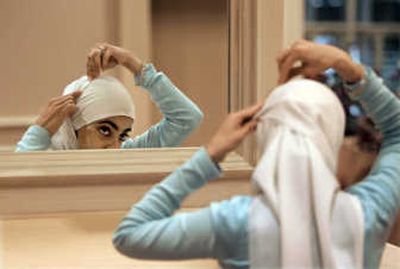 
Sadaf Butt, of Alabama, adjusts her hijab in a mirror at the 43rd annual Islamic Society of North America convention, Sept. 1, 2006, in Rosemont, Ill. Many Muslim women in America are moving away from the traditional head covering. Associated Press
 (Associated Press / The Spokesman-Review)
