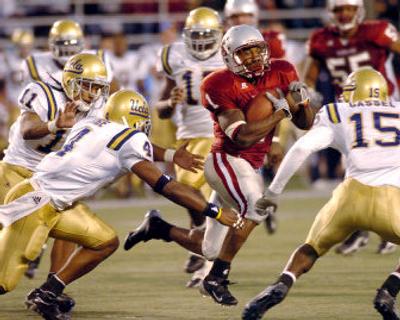 
Washington State University running back Jerome Harrison, evading UCLA defenders during an Oct. 15 game, aims to tie a premier Pacific-10 Conference record this weekend. 
 (Associated Press / The Spokesman-Review)