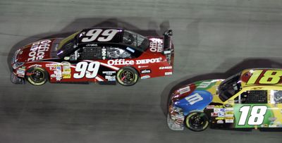 Carl Edwards passes Kyle Busch during the final few laps of the NASCAR Sprint Cup Series Sharpie 500 Saturday. (Associated Press / The Spokesman-Review)