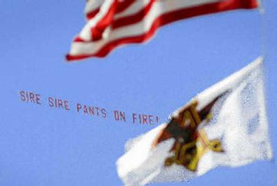 
A banner is shown last week flying around the Anheuser-Busch flag flying above the St. Louis brewery reading 