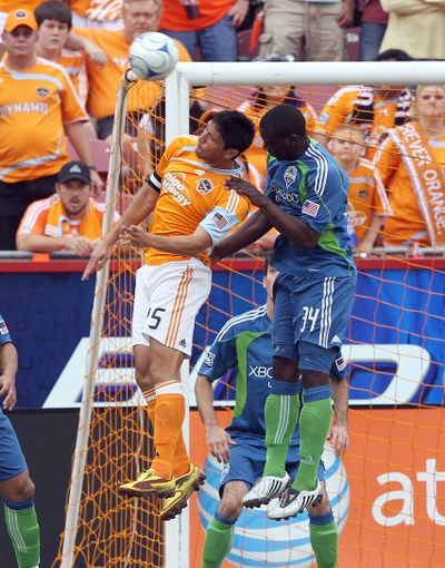 Houston’s Brian Ching, left, and Seattle’s Jhon Kennedy Hurtado go up for a header. (Associated Press / The Spokesman-Review)