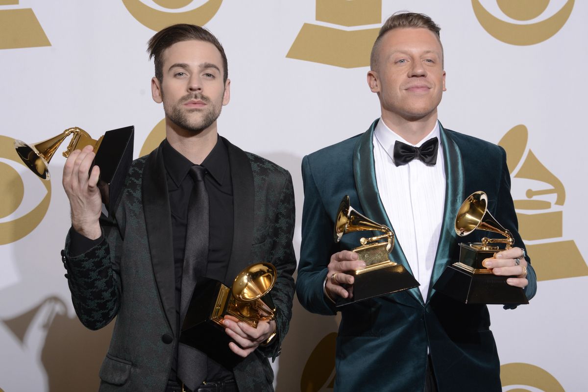 In this Jan. 26, 2014, photo, Ryan Lewis and Macklemore stand in the press room with their awards for Best Rap Performance and Best Rap Song for “Thrift Shop,” Best Rap Album for “The Heist” and Best New Artist at the 56th Annual Grammy Awards in Los Angeles.  (Dan Steinberg/Invision/Associated Press)
