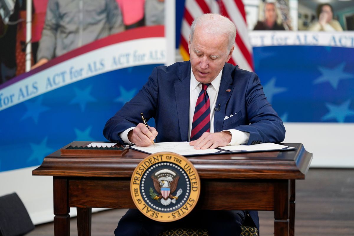 President Joe Biden signs the “Accelerating Access to Critical Therapies for ALS Act” into law during a ceremony in the South Court Auditorium on the White House campus in Washington, Thursday, Dec. 23, 2021.  (Associated Press )