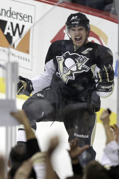 Pittsburgh’s Sidney Crosby celebrates his nearly year-long absence from the ice with a first-period goal on Monday. (Associated Press)