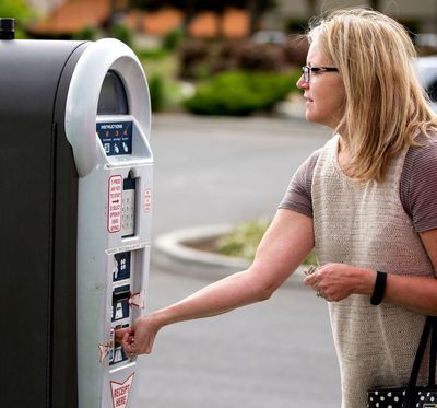 Sharon Miller purchases three hours of parking using a pay kiosk on Thursday at McEuen parking facility. A recent parking study revealed the need for five more pay kiosks in the facility. (Jake Parrish/Coeur d'Alene Press photo)