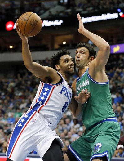 Philadelphia 76ers center Jahlil Okafor, left, drives to the basket against Dallas Mavericks' Zaza Pachulia for a shot in the first half of an NBA basketball game, Sunday, Feb. 21, 2016, in Dallas. Okafor will have knee surgery and miss the remainder of the NBA season. (Tony Gutierrez / Associated Press)