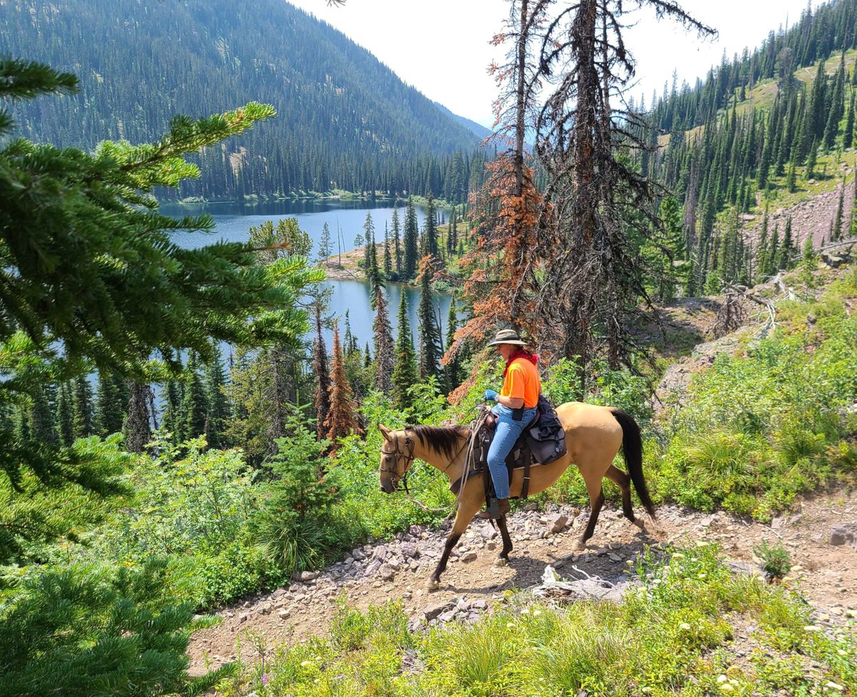 Passing Upper Holland Lake, a customer with Rich’s Montana Guest Ranch rides out of the Bob Marshall Wilderness on the last of a 10-day horsepacking trip in July-August.  (Rich Landers/The Spokesman-Review)