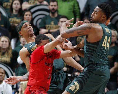 Michigan State's Miles Bridges, left, and Nick Ward fight for the ball with Maryland's Anthony Cowan. The Spartans won 91-61. (Al Goldis / Associated Press)