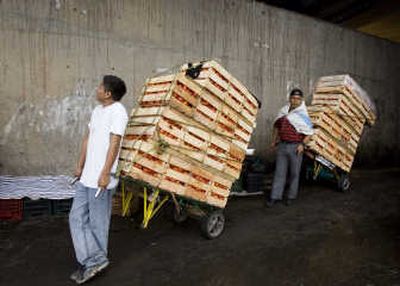 
Workers stand with crates of tomatoes at the Central de Abastos market in Mexico City on Thursday. Associated Press
 (Associated Press / The Spokesman-Review)