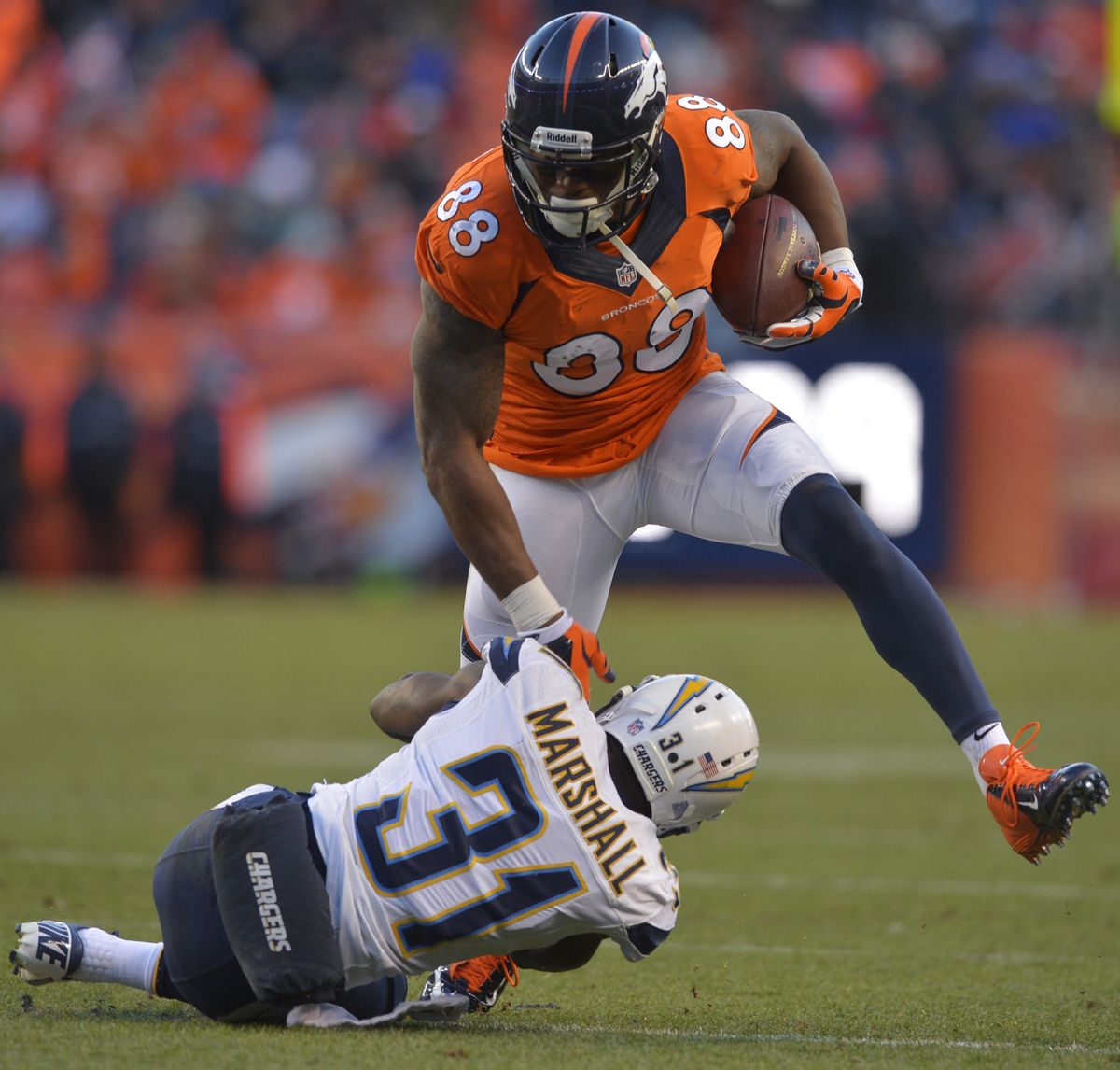 Broncos wide receiver Demaryius Thomas steps over Chargers cornerback Richard Marshall. (Associated Press)