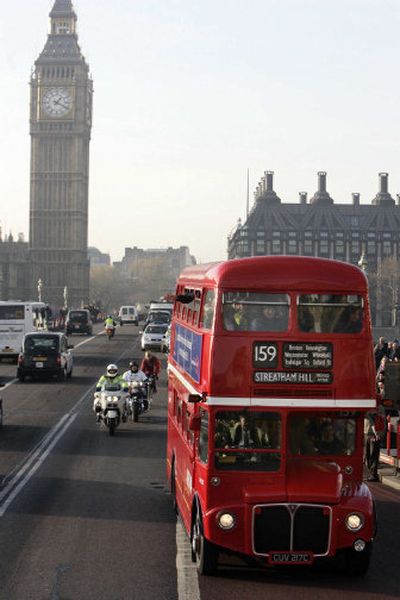 
London's last double-decker Routemaster bus passes by the Houses of Parliament on Friday. Thousands came out for a last look at the old bus that has served the capital since the 1950s. 
 (Associated Press / The Spokesman-Review)