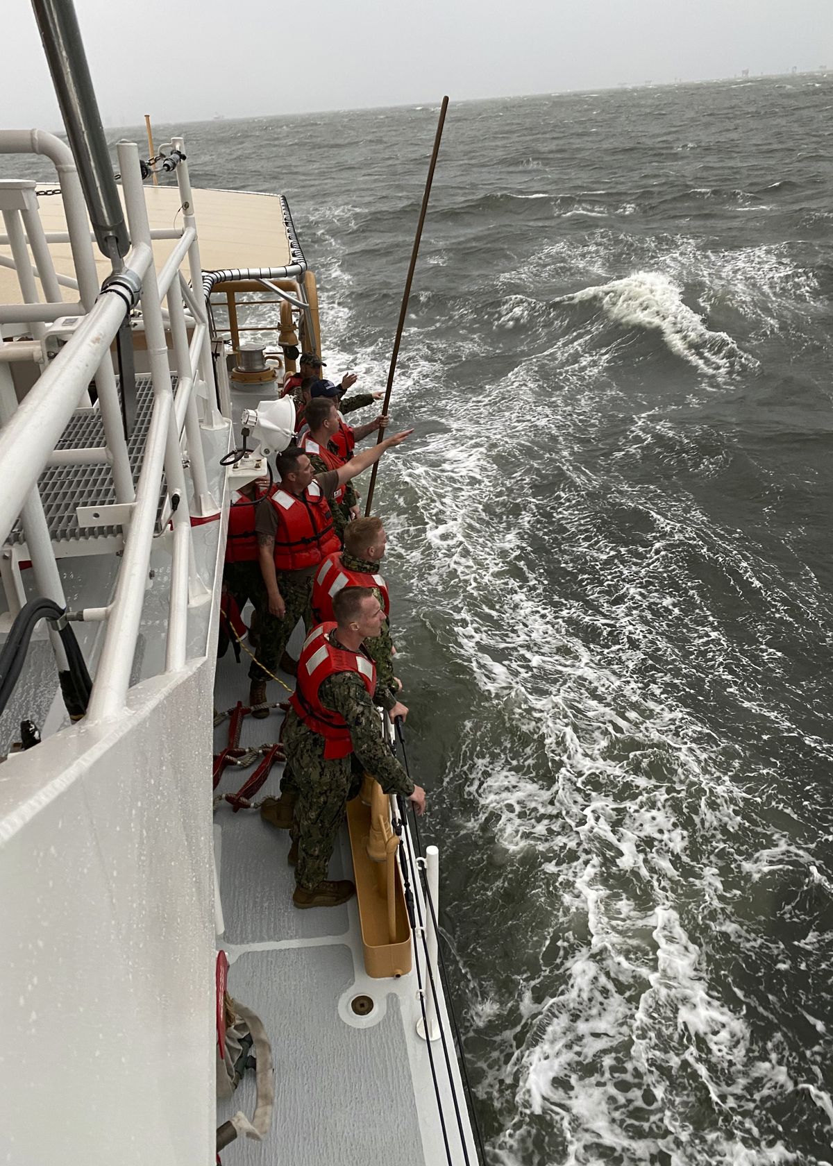In this photo provided by the U.S. Coast Guard, crew members of the Coast Guard Cutter Glenn Harris search for survivors Tuesday, April 13, 2021 after a 175-foot commercial lift boat capsized 8 miles south of Grand Isle, La. The Seacor Power, an oil industry vessel, flipped over Tuesday in a microburst of dangerous wind and high seas.  (HOGP)