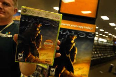 
Kevin Pardue, the manager of the South Hill Hastings, holds a copy of the new Xbox 360 game 