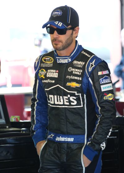 Jimmie Johnson watches his crew work on his car Saturday. (Associated Press)