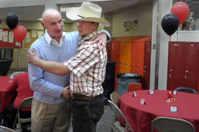 Jim Harrison, left,  congratulates Tony Stasch on  Wednesday at a celebration for North Central High School seniors who will be the first in their families to graduate from high school, go to college or both. Harrison taught Stasch in the sixth grade at Balboa Elementary School.  (CHRISTOPHER ANDERSON / The Spokesman-Review)