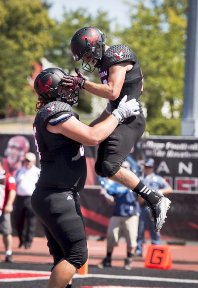 Offensive lineman Jack Rodgers, left, and receiver Blair Bomber celebrate after Bomber's TD catch in the 2014 season opener against Sam Houston State. Rodgers and Bomber both transferred from Washington State University. (Colin Mulvany)