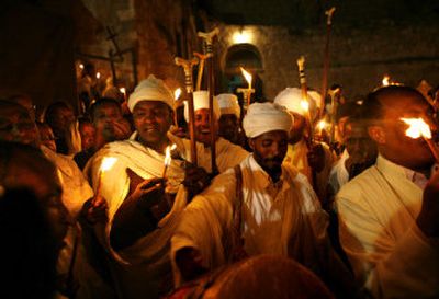 
Ethiopian Orthodox Christians sing and dance outside Deir Al-Sultan in the Church of the Holy Sepulcher during the ceremony of the holy fire in Jerusalem's Old City on Saturday. 
 (Associated Press / The Spokesman-Review)