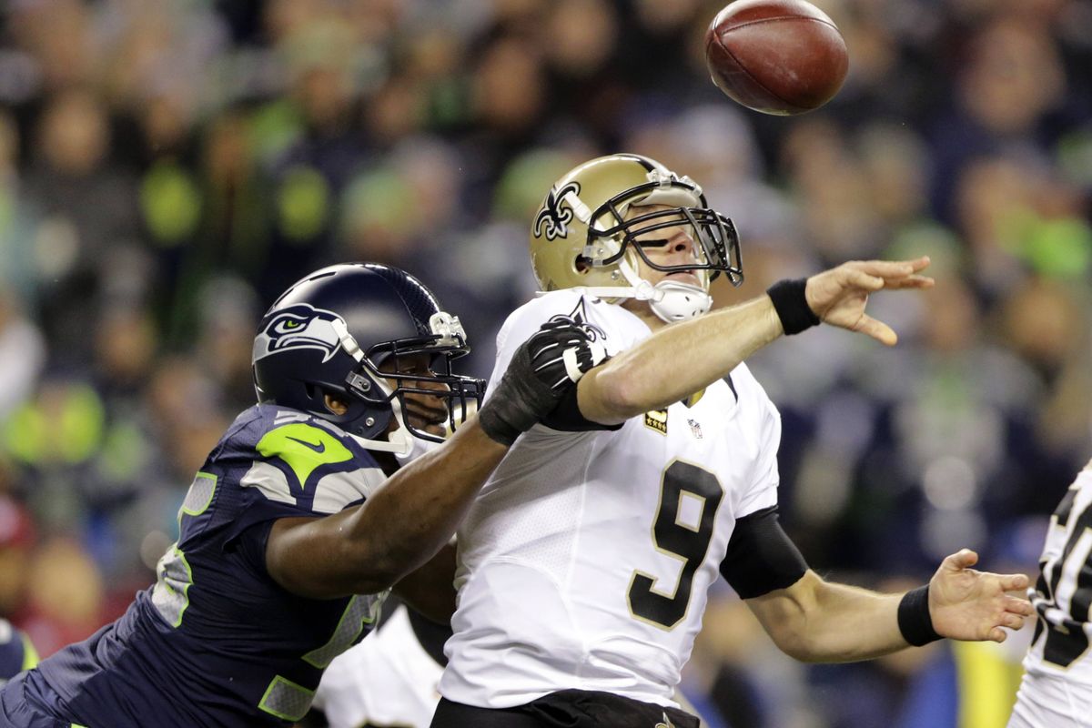 Seahawks defensive end Cliff Avril sacks Saints QB Drew Brees, forcing a fumble that was returned for a touchdown … (Associated Press)