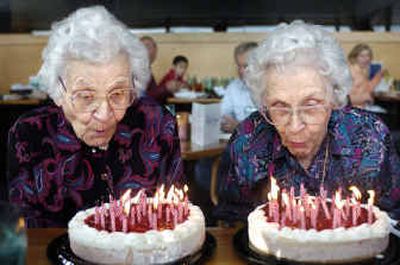 
Twins Kathleen and Ethlyn DeCamp blow out 97 candles during their birthday party at Anthony's restaurant Thursday afternoon. The sisters  still live together. 
 (Holly Pickett / The Spokesman-Review)