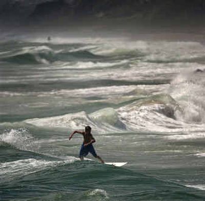
A lone surfer rides the heavy surf from Hurricane Frances that has begun to pound the coast of Florida Thursday at the Boynton Inlet looking south toward Delray Beach, Fla. 
 (Associated Press / The Spokesman-Review)