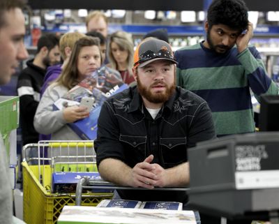 People line up to check out as they shop a Black Friday sale at a Best Buy store on Thanksgiving Day, Nov. 23, 2017, in Overland Park, Kan. (Charlie Riedel / Associated Press)