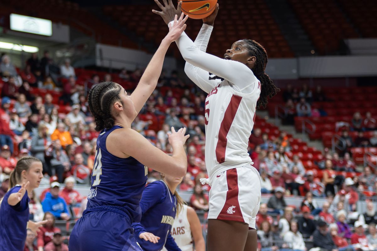 Washington State center Bella Murekatete, right, shoots under pressure from Washington forward Dalayah Daniels in the first half on Sunday, Dec. 10, 2023 at Beasley Coliseum in Pullman, Wash.  (Geoff Crimmins/For The Spokesman-Review)