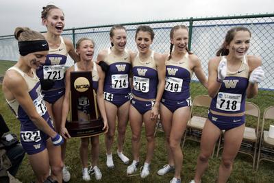 The UW women, celebrating the championship, finished the season undefeated. (Associated Press / The Spokesman-Review)