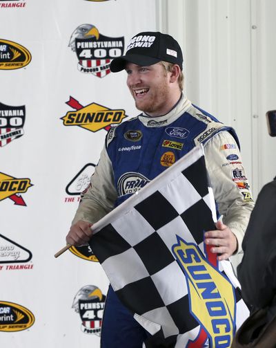 Chris Buescher, holding the checkered flag after winning the bad weather-shortened Sprint Cup series race at Pocono Raceway on Aug. 1, 2016, has a chance to make the Chase. (Mel Evans / Associated Press)