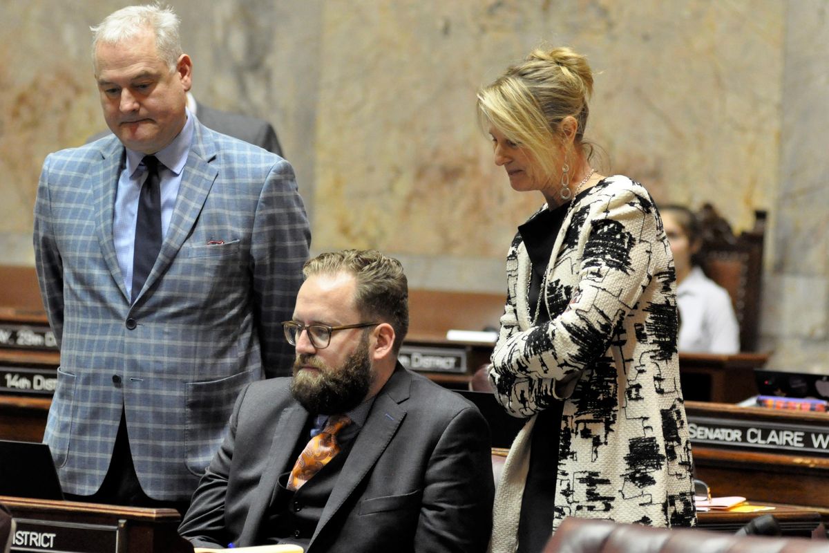 OLYMPIA – Sen. Reuven Carlyle, D-Seattle, far left, watches the vote count Friday on a bill to eliminate the death penalty from state law with Sens. Marko Liias, D-Seattle, and Patty Kuderer, D-Bellevue. The bill passed 28-18. (Jim Camden / The Spokesman-Review)