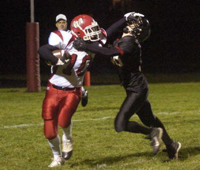 
Clarkston's Brian O'Kelley fends off Cheney's Chad Curtis in the first quarter Friday night in Cheney.
 (Dan Pelle / The Spokesman-Review)