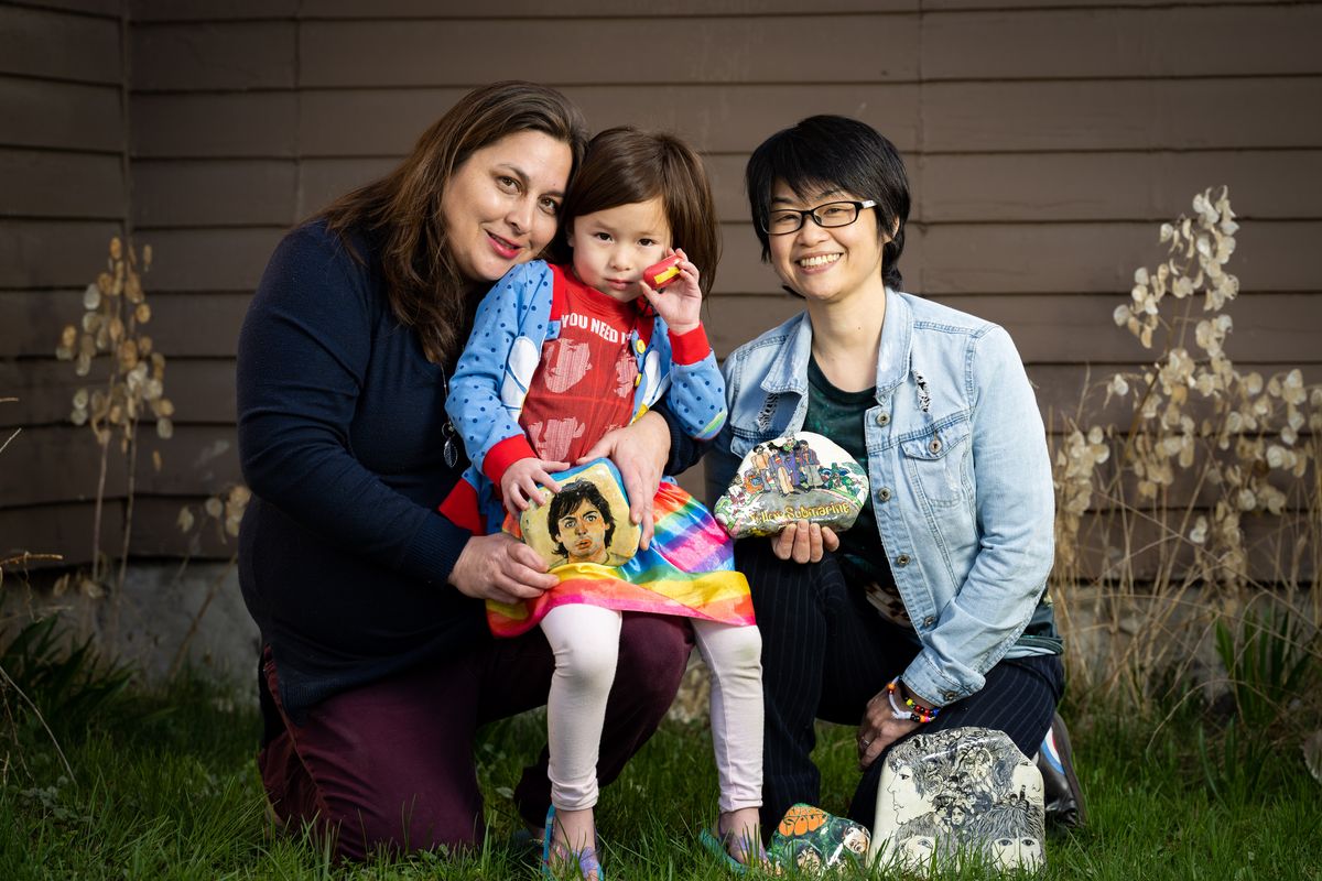 Christina Mitma, left, and Ayuko Momono eat, breathe and live the Beatles – well, at least Momono does – and they are taking their 4-year-old daughter Yulianna to Paul McCartney at Spokane Arena on April 28 for her first concert. Momono is a longtime fan, performs Beatles music, has an extensive memorabilia collection and creates Beatles artwork such as these painted rocks. Her ticket alone for the concert was $1,650.  (Colin Mulvany/The Spokesman-Review)