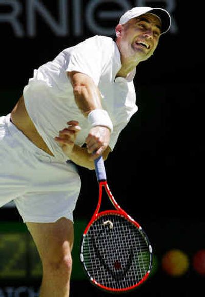 
Andre Agassi serves to Joachim Johansson of Sweden during a fourth-round match. Agassi won 6-7, 7-6, 7-6, 6-4. 
 (Associated Press / The Spokesman-Review)