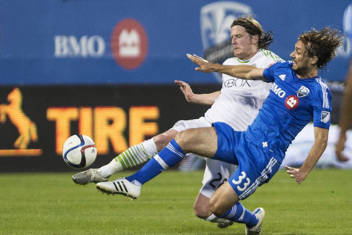 Impact defender Marco Donadel, right, challenges Sounders midfielder Erik Friberg during the first half in Montreal on Saturday. (Canadian Press)