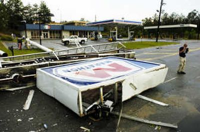 
Chris Bryant stands  near a downed sign in Macon, Ga., on Sunday. Associated Press
 (Associated Press / The Spokesman-Review)