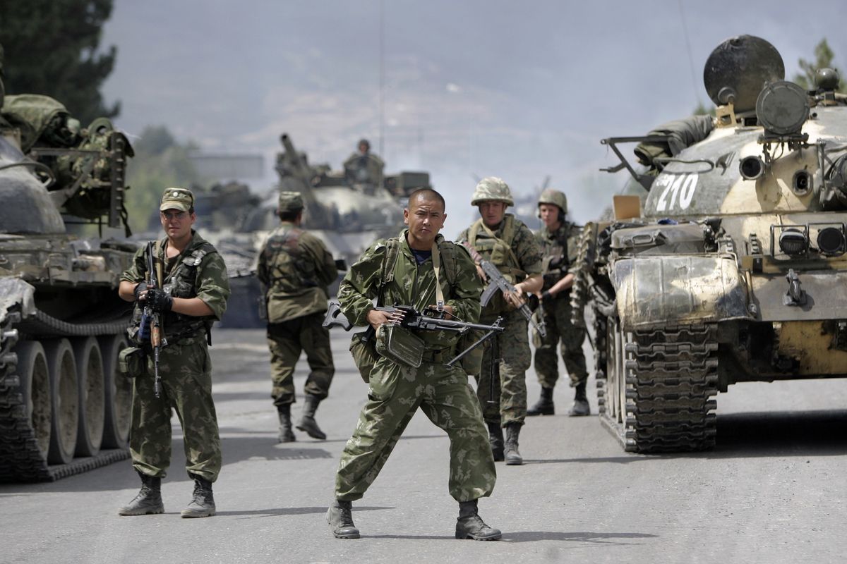 FILE - In this Thursday, Aug. 14, 2008 file photo, Russian soldiers block the road on the outskirts of Gori, northwest of the capital Tbilisi, Georgia. The European Court of Human Rights ruled Thursday, Jan. 21, 2021 that Russia was responsible for a swathe of violations in Georgia