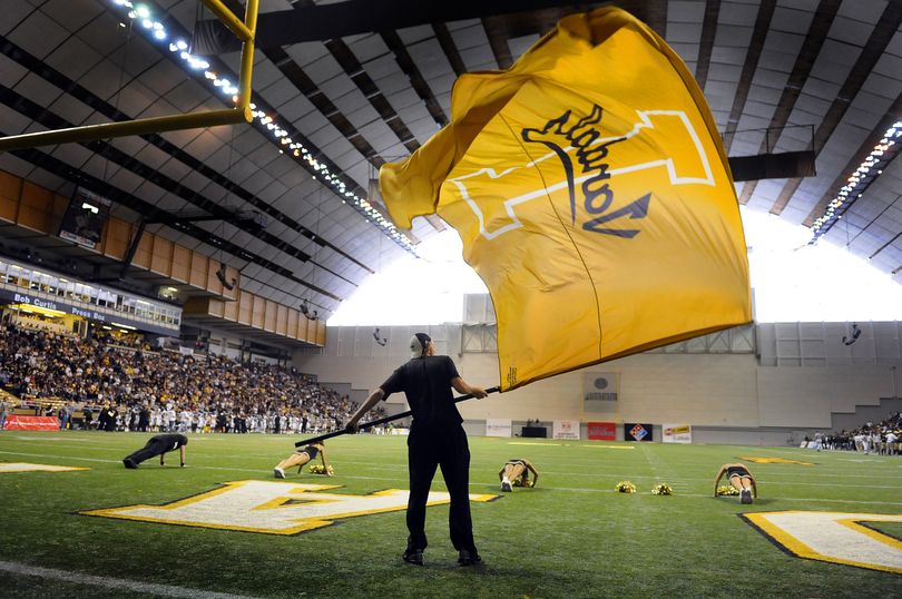 The Idaho cheerleading squad show the flag and do pushups equal to the score after the Vandals make the first TD of the game against Hawaii in the Kibbie Dome on Saturday, Oct. 17, 2009. (Christopher Anderson / The Spokesman-Review)