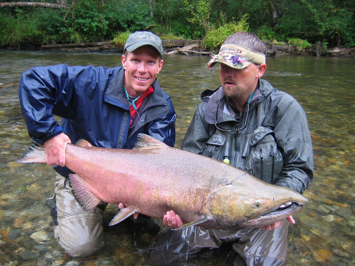 Now: Gonzaga men’s basketball coach Mark Few beams over a 50-pound Alaska king salmon he landed with the help of fly fishing guide Joe Roope Jr., who’s soaking wet after belly-flopping on the lunker to keep it from breaking off in a log jam. “Few’s a competitor on the river, too,” Roope recalled. “We all wanted that fish.” (Photo courtesy of Greg Heister / The Spokesman-Review)