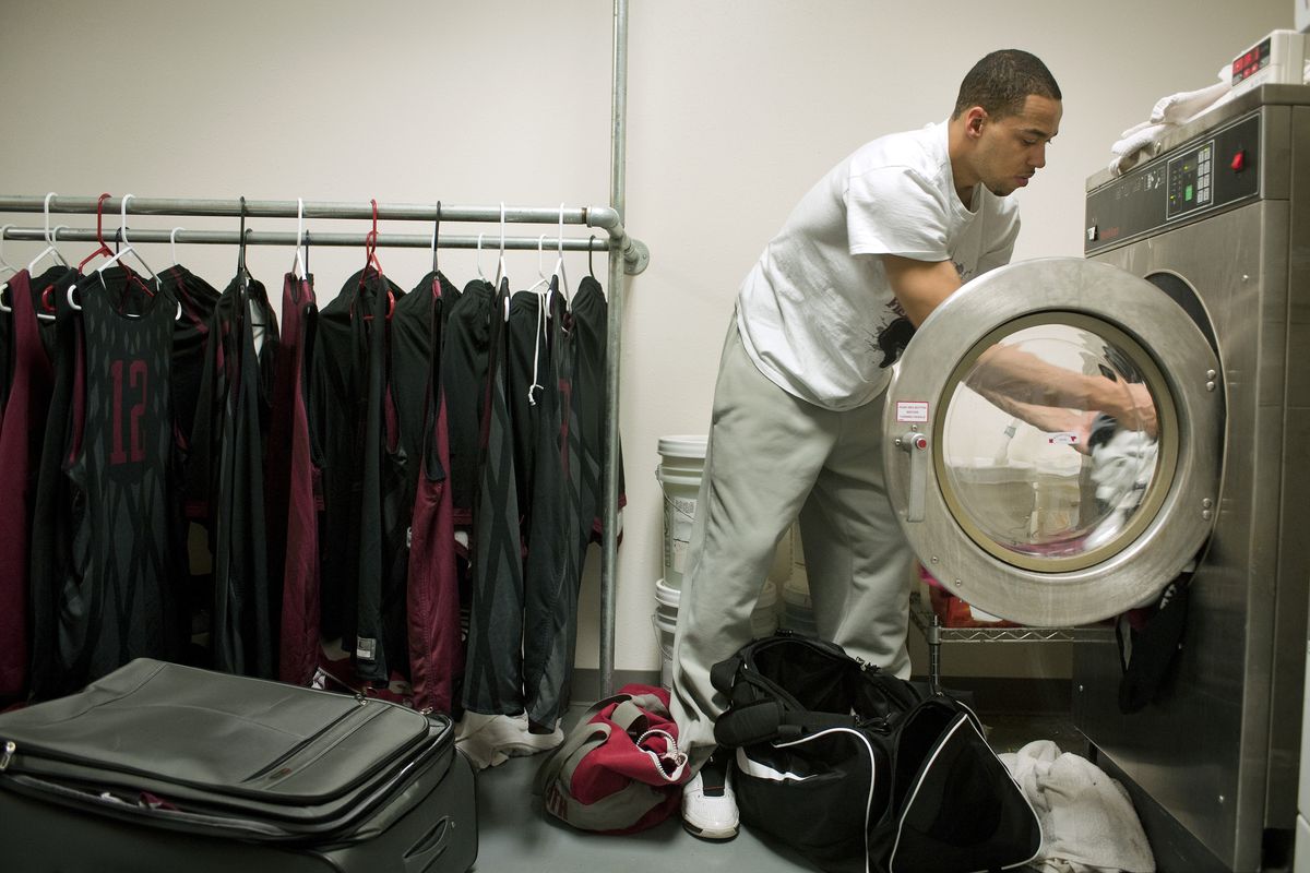 Whitworth men’s basketball player Idris Lasisi helps pay for bills by doing custodial work, including the Pirates’ laundry. (Colin Mulvany)