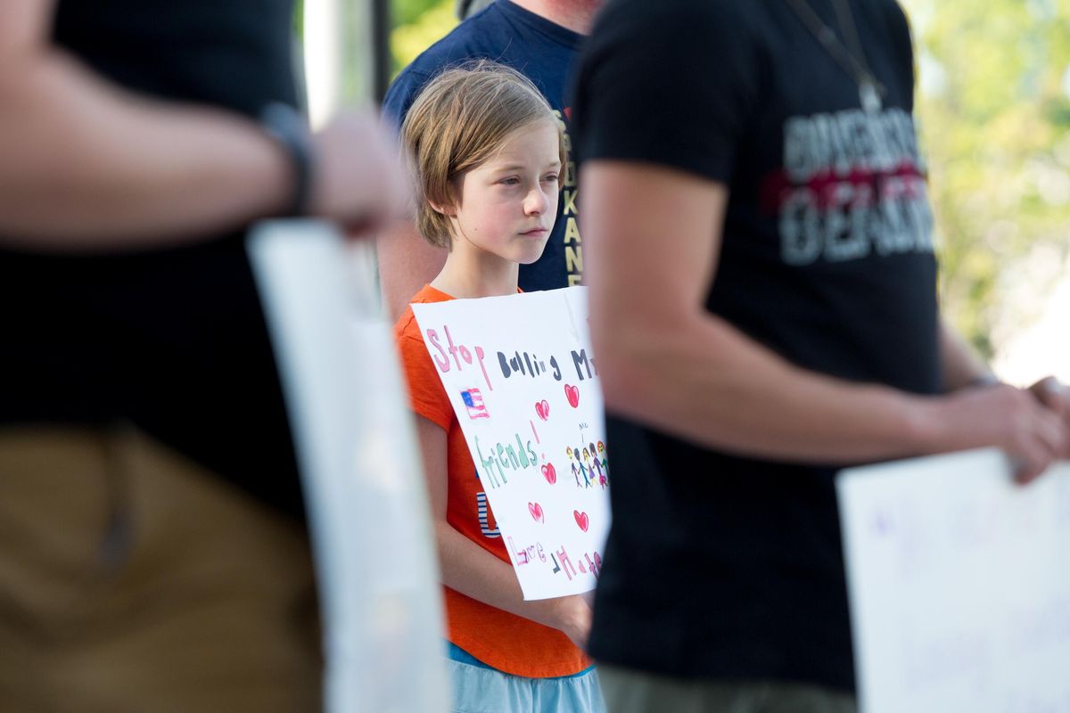 Ellie Weitz holds a sign she made that shows her diverse friend group during a rally in reaction to racist marches and subsequent violence in Charlottesville, Va., on Monday, Aug. 14, 2017 outside Spokane City Hall. (Tyler Tjomsland / The Spokesman-Review)