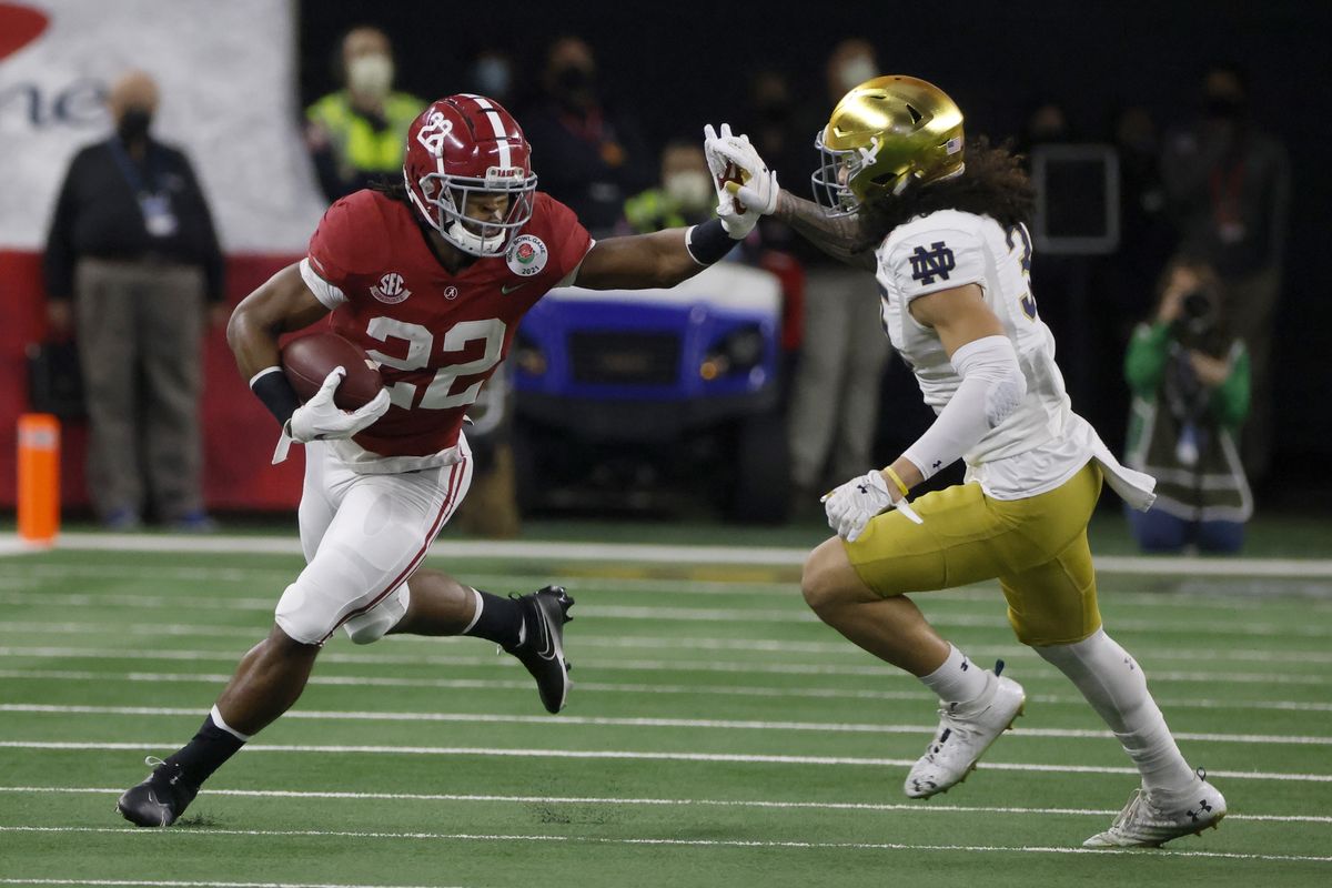Alabama running back Najee Harris fights off a tackle attempt by Notre Dame linebacker Marist Liufau during the first half of the Rose Bowl on Friday.  (Associated Press)