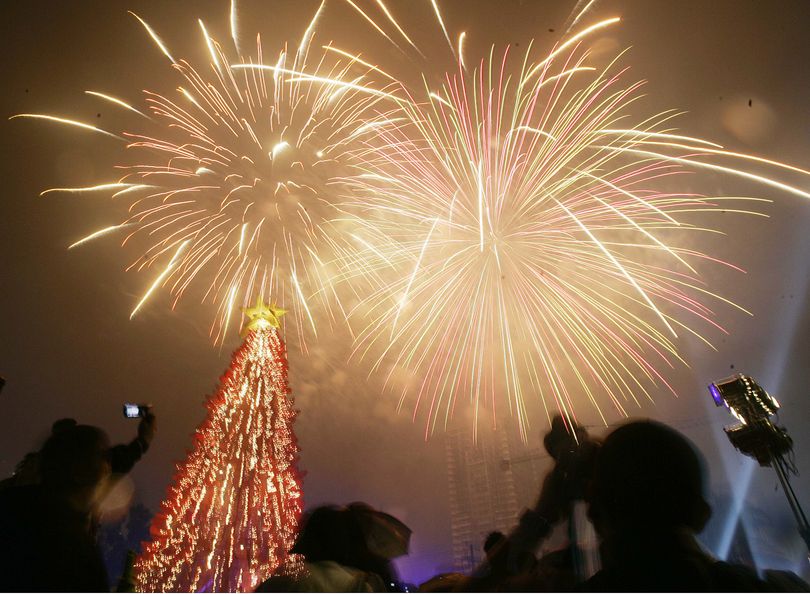 Filipino revelers watch a fireworks display in suburban Manila, Philippines, during celebrations of New Years Day on Thursday, Jan. 1, 2009.  (Aaron Favila / Associated Press)
