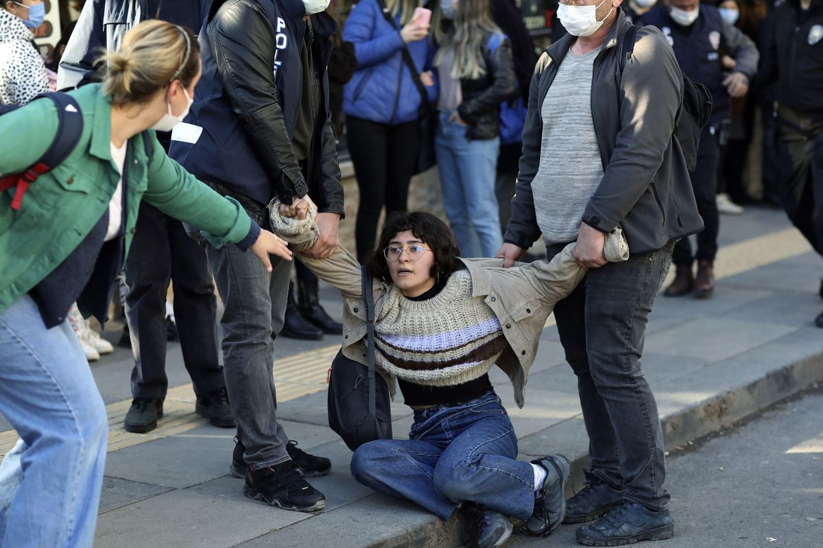 A woman reacts as riot police officers detain a student during a protest, in Ankara, Turkey, Friday, Feb. 5, 2021. Students and faculty members at Bogazici University have been staging demonstrations in protest of President Recep Tayyip Erdogan
