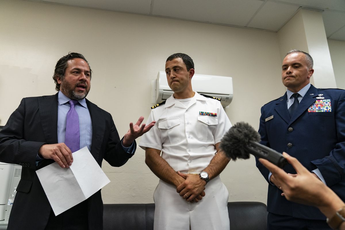 Attorneys Brian Bouffard, left, accompanied by U.S. Navy Lt. Cmdr. Aaron Shephard, and U.S. Air Force Major Jason Cordova, speak with reporters after the second day of an arraignment hearing for their client Malaysian defendant Mohammed Nazir bin Lep, Tuesday, Aug. 31, 2021, in Guantanamo Bay Naval Base, Cuba. Three prisoners at the Guantanamo Bay detention center had their second day in court Tuesday after being held by the U.S. for 18 years without charge in connection with the deadly 2002 Bali nightclub bombings and other plots in Southeast Asia.  (Alex Brandon)