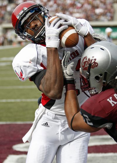Eastern Washington wide receiver Nicholas Edwards catches a pass for a two-point conversion over Montana linebacker John Kanongata in the Big Sky matchup in Missoula earlier this season. (Associated Press)