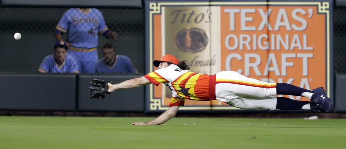 Houston Astros center fielder Jake Marisnick dives and makes the catch on a fly ball by Seattle Mariners