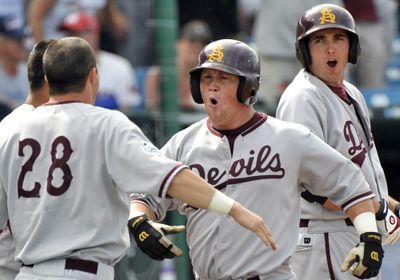 Arizona State’s Kole Calhoun, center, celebrates his three-run home run in the 10th inning. (Associated Press / The Spokesman-Review)