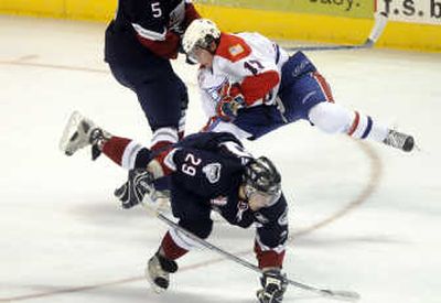 
Spokane's Justin McCrae, top, collides with Lethbridge's Mike Wuchterl, bottom, at midice, earning McCrae a penalty. The Spokesman Review
 (JESSE TINSLEY The Spokesman Review / The Spokesman-Review)