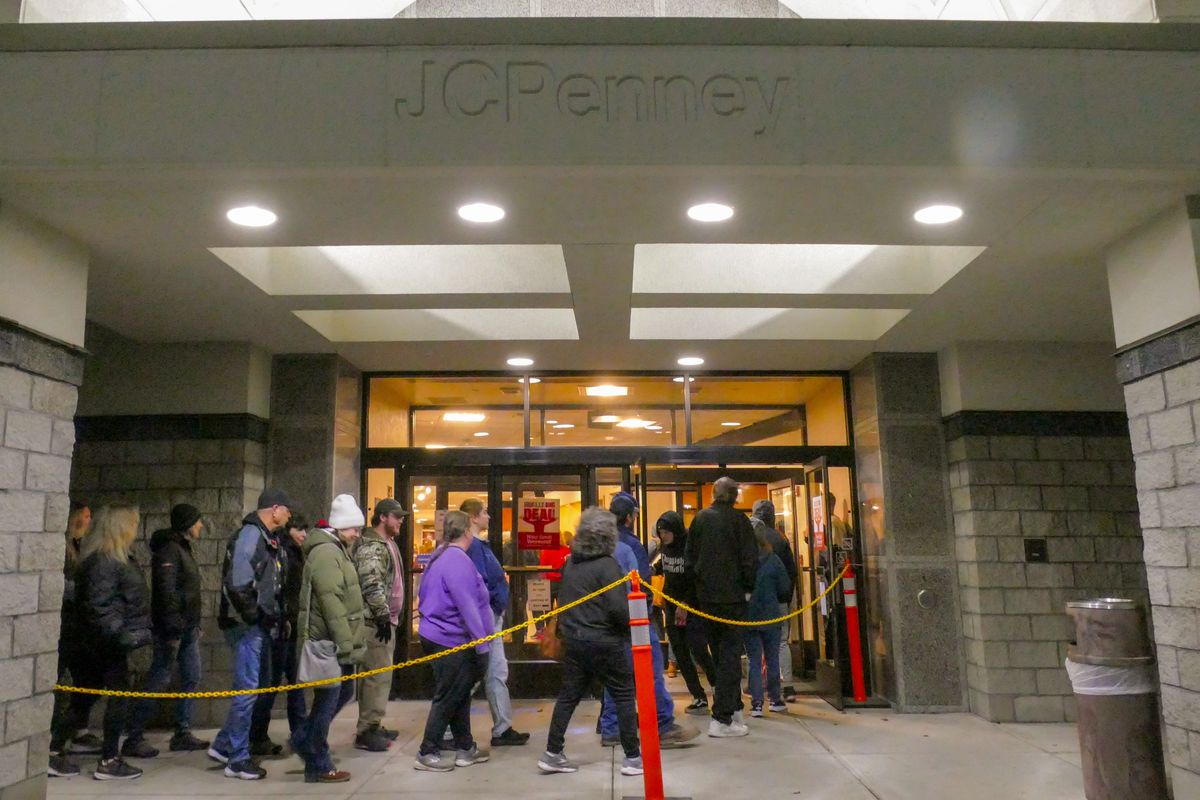 Shoppers file in at the 5 a.m. opening JCPenney on Friday at the Spokane Valley Mall. A large crowd was enticed by coupons, ranging from percentage discounts up to generous gift certificates and free souvenir snow globes.  (Jesse Tinsley/THE SPOKESMAN-REVIEW)